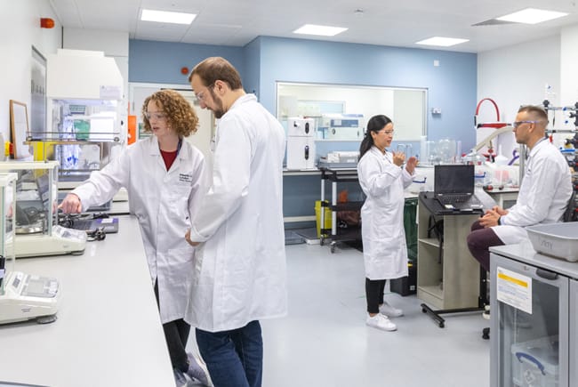 scientists together working within a lab