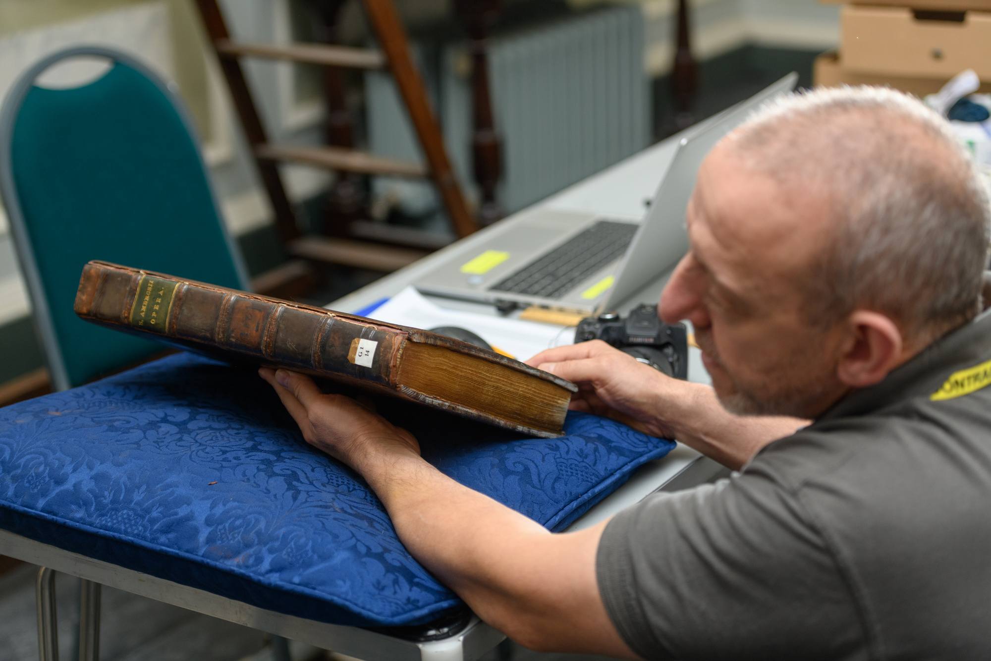 man handling precious book as part of heritage relocation
